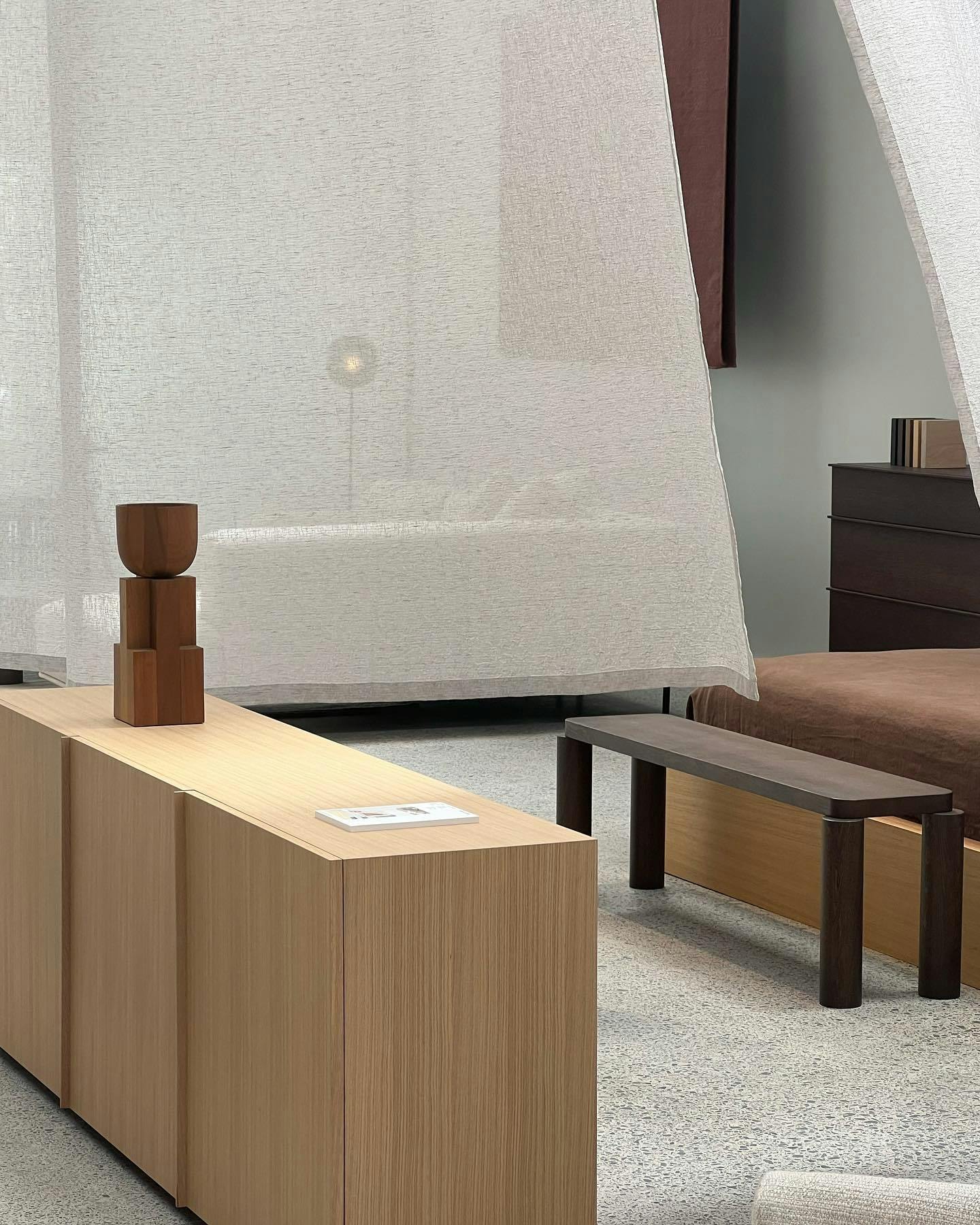 Wide angle of a bedroom with Simon James side table, bed and bench