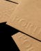 Close up of cardboard packaging with Porter Packaging logo embossed
